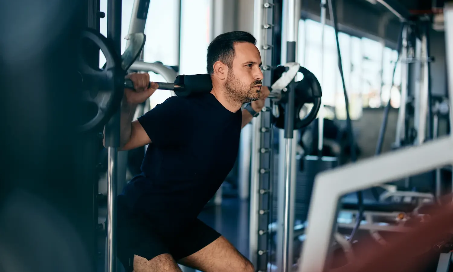 Smith Machine Squat: How to Do It, Muscles Worked & Common Mistakes