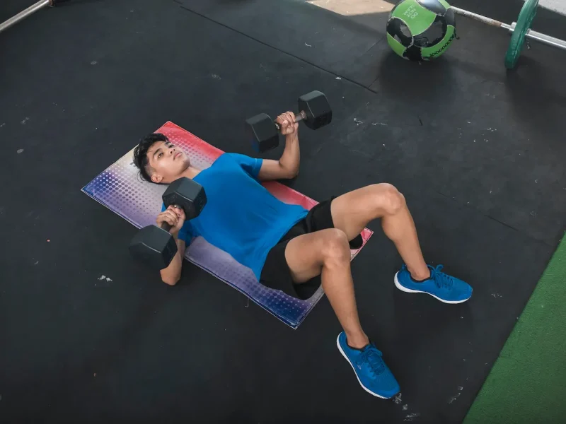 Dumbbell Floor Press: How to Do It, Muscles Worked & Common Mistakes
