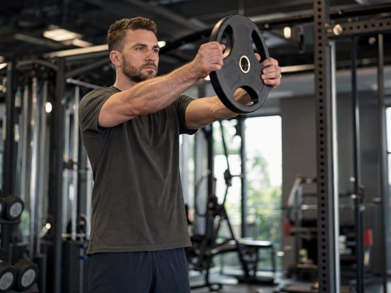 Plate Front Raise: How to Do It, Muscles Worked & Common Mistakes